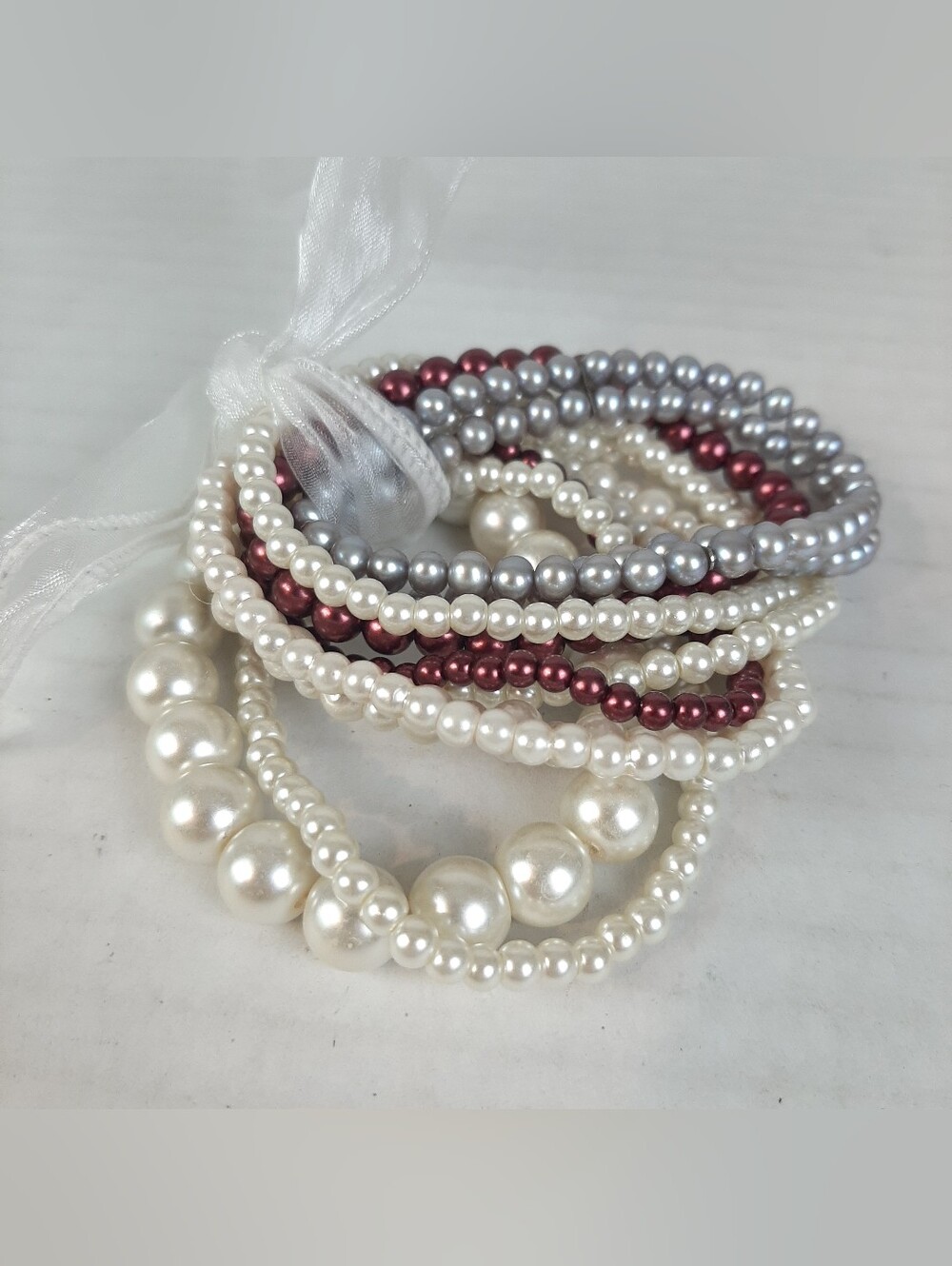 Set of white maroon and gray faux pearl stretch bracelets